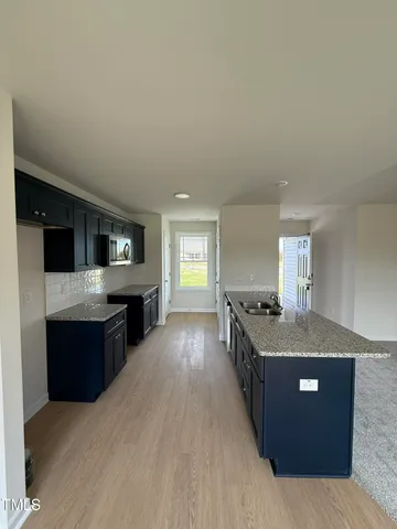 a kitchen with stainless steel appliances granite countertop a stove and a sink