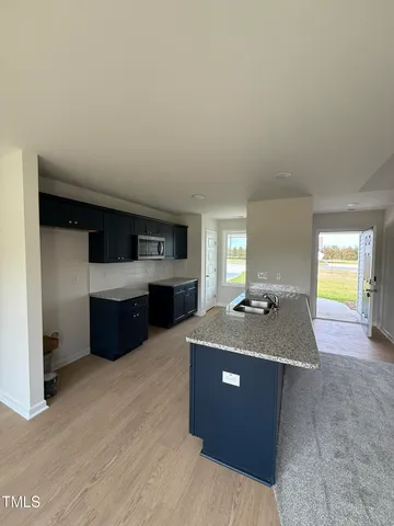 a kitchen with stainless steel appliances granite countertop a sink a stove top oven a counter space and cabinets