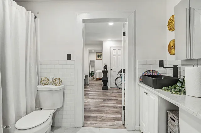 a bathroom with a sink a toilet and mirror