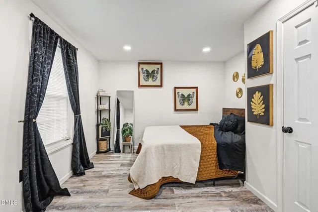 a bed room with a bed and a window