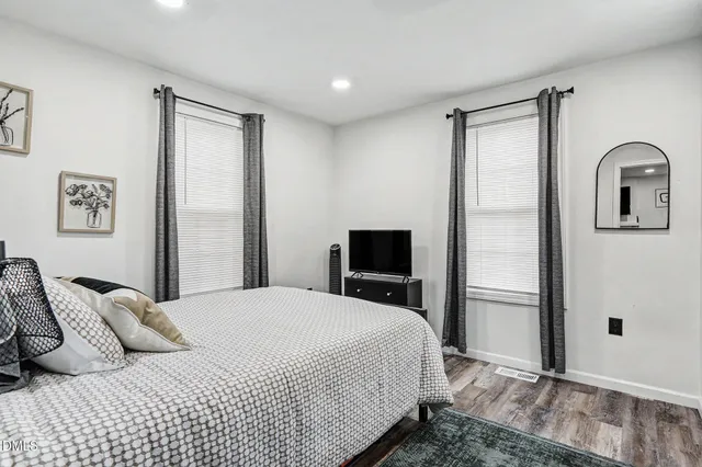 a bedroom with a bed and a large mirror