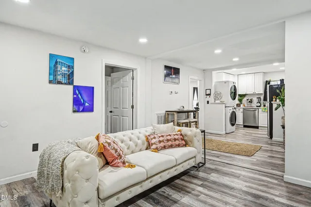 a living room with furniture and kitchen view