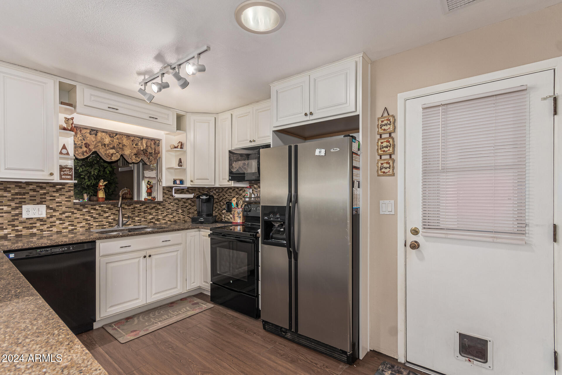 849 North 67th Place Mesa, AZ 85205 - Photo 12 of 47 a kitchen with stainless steel appliances granite countertop a refrigerator and a sink