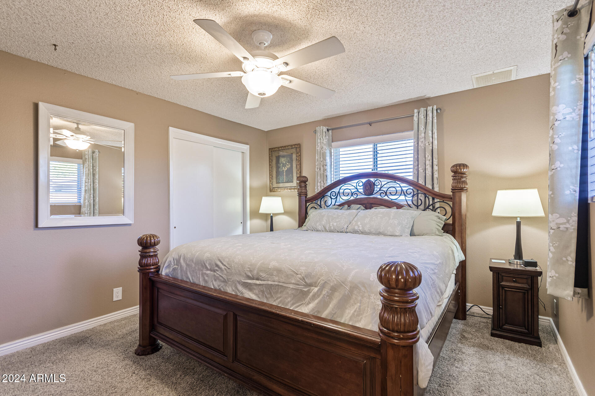 849 North 67th Place Mesa, AZ 85205 - Photo 15 of 47 a bedroom with a bed and a chandelier
