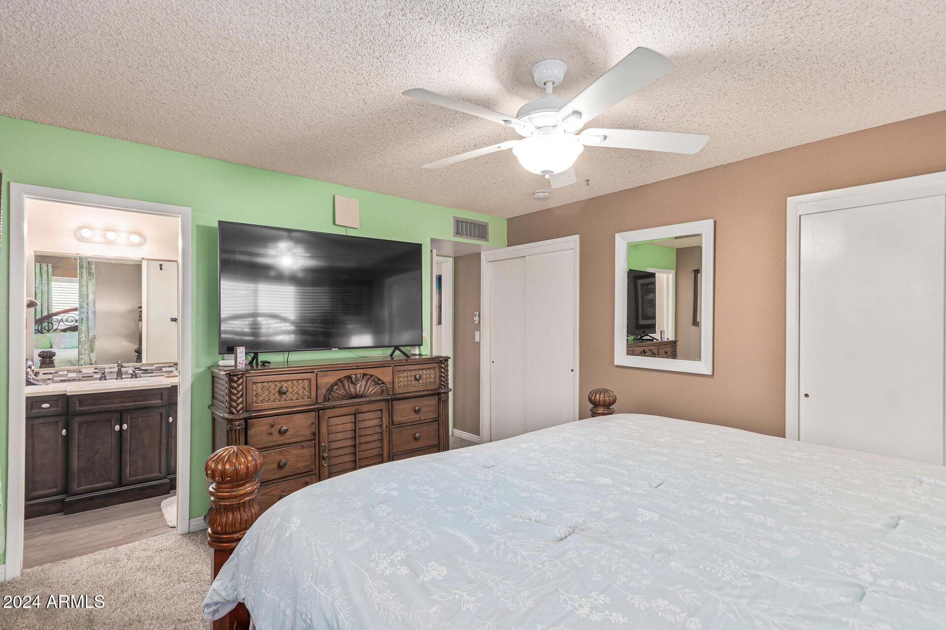 849 North 67th Place Mesa, AZ 85205 - Photo 16 of 47 a bedroom with a bed and a flat screen tv