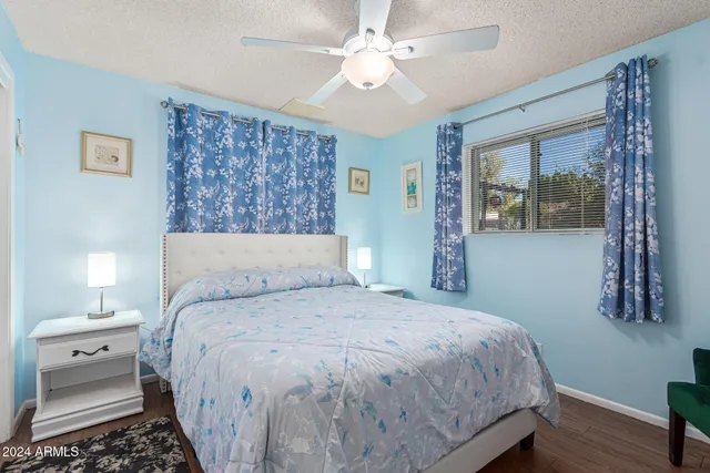 a bedroom with a large bed and a chandelier