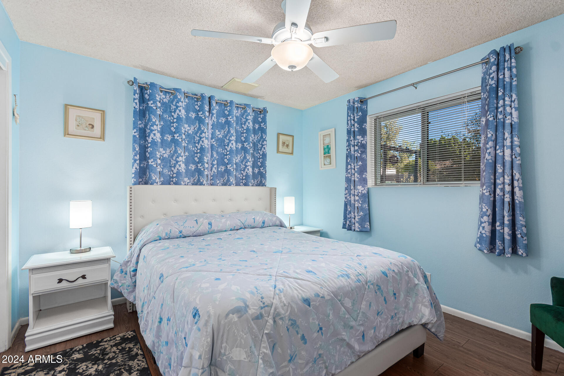 849 North 67th Place Mesa, AZ 85205 - Photo 18 of 47 a bedroom with a large bed and a chandelier