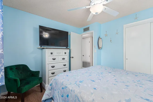 a bedroom with a bed and a flat screen tv