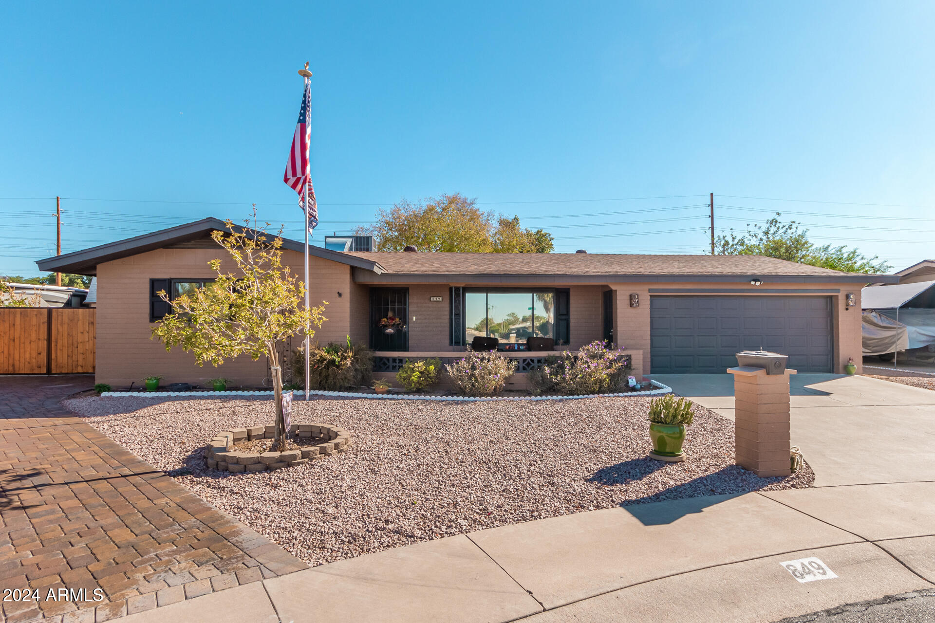 849 North 67th Place Mesa, AZ 85205 - Photo 2 of 47 a front view of a house with garden