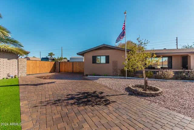 a house with pool garden and wooden fence