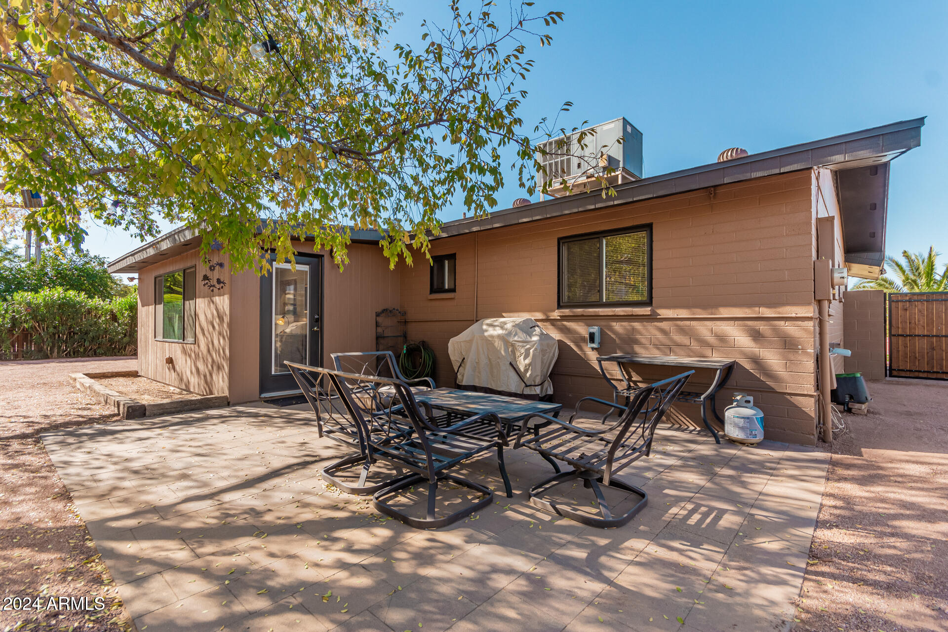 849 North 67th Place Mesa, AZ 85205 - Photo 33 of 47 a backyard of a house with table and chairs
