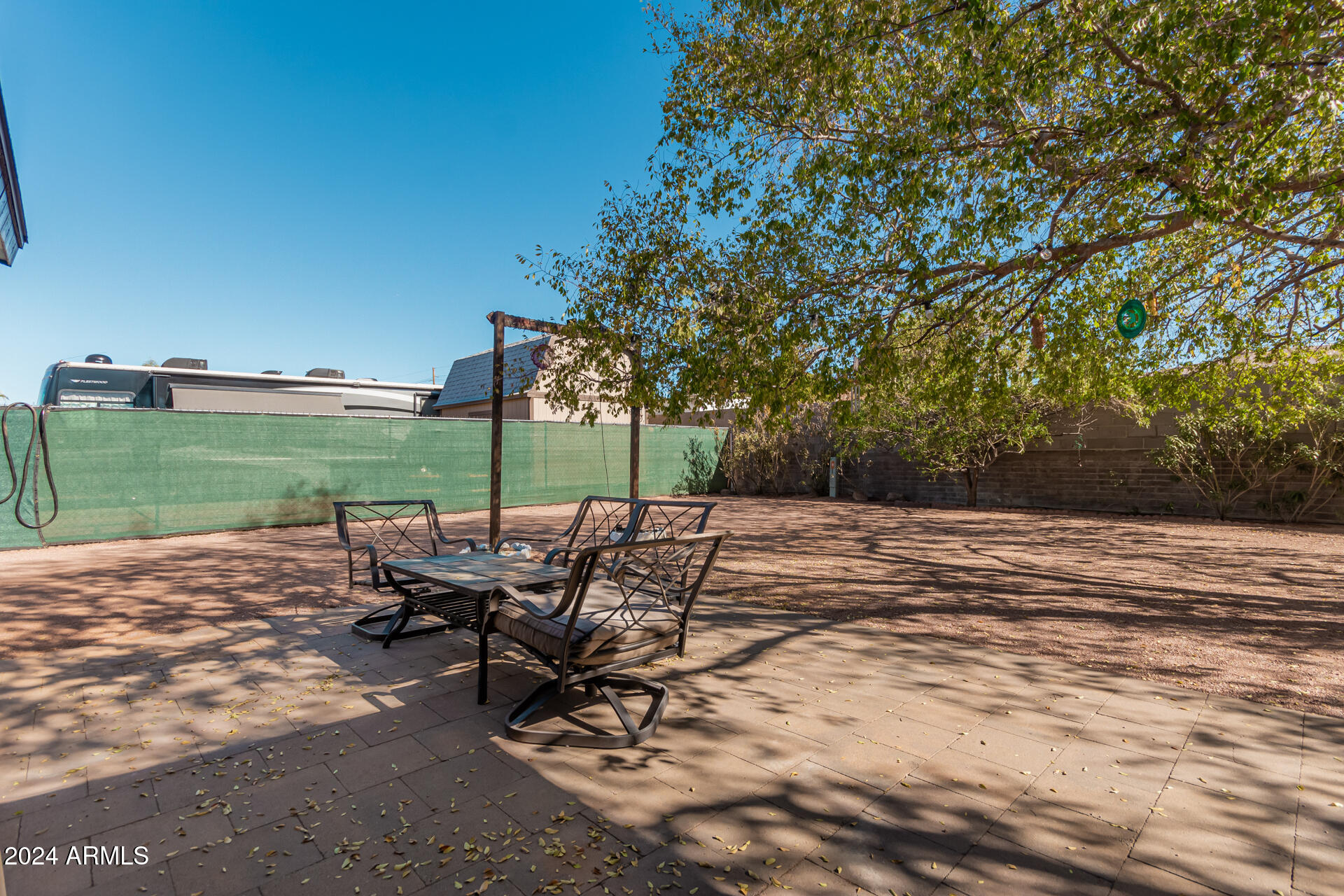 849 North 67th Place Mesa, AZ 85205 - Photo 36 of 47 a view of a patio with a table and chairs under an umbrella