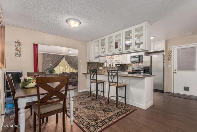 a living room with dining room and wooden floor