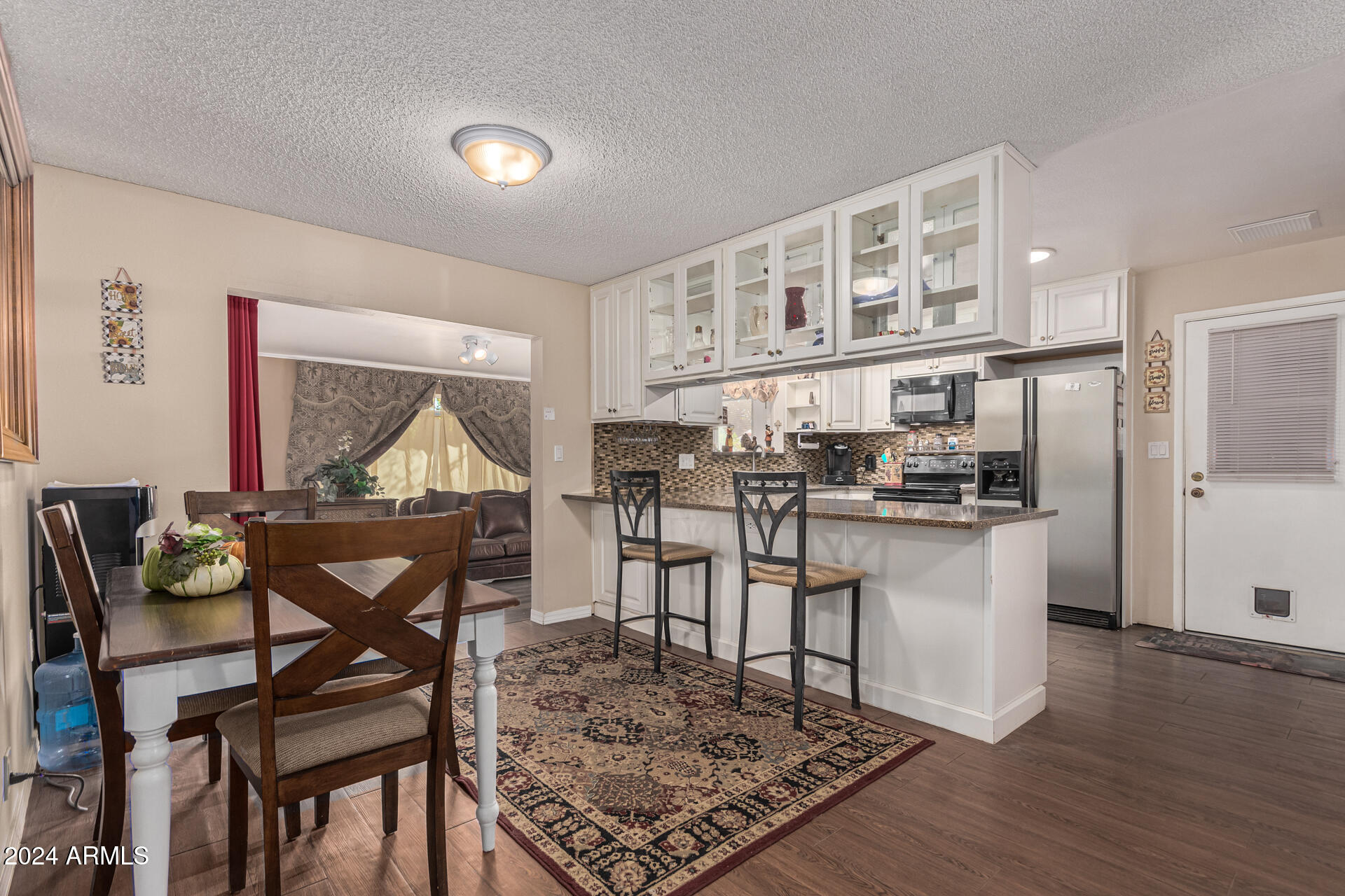 849 North 67th Place Mesa, AZ 85205 - Photo 6 of 47 a living room with dining room and wooden floor