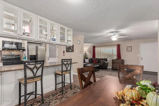 a living room with fireplace furniture and a wooden floor
