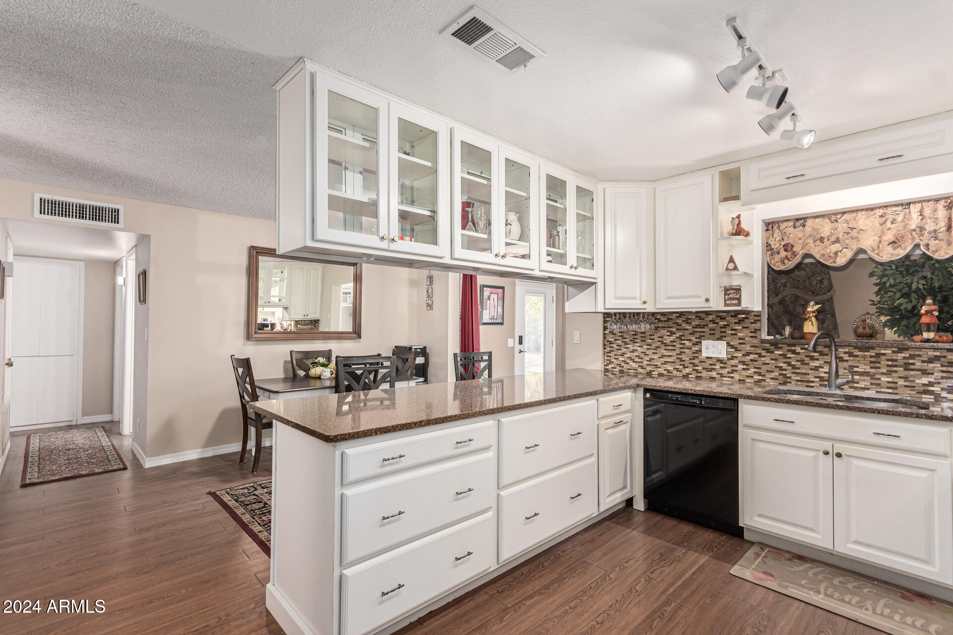 849 North 67th Place Mesa, AZ 85205 - Photo 10 of 47 a kitchen with a stove and white cabinets