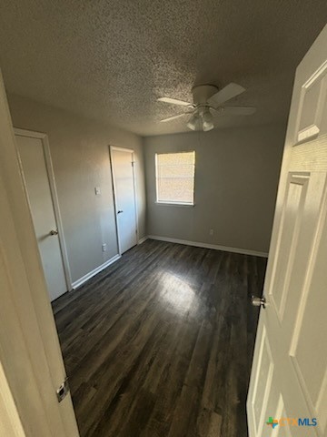 613 Stringer Street, Unit 4 Killeen, TX 76541 - Photo 6 of 7 an empty room with wooden floor and windows