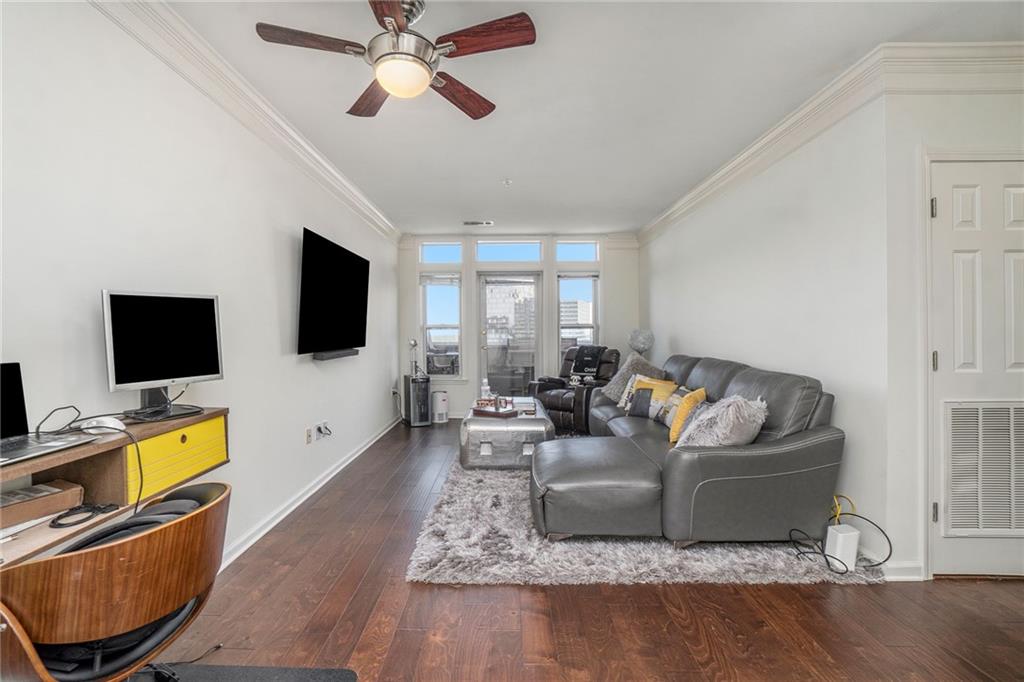 3334 Peachtree Road Northeast, Unit 1610 Atlanta, GA 30326 - Photo 1 of 1 a living room with furniture and a flat screen tv