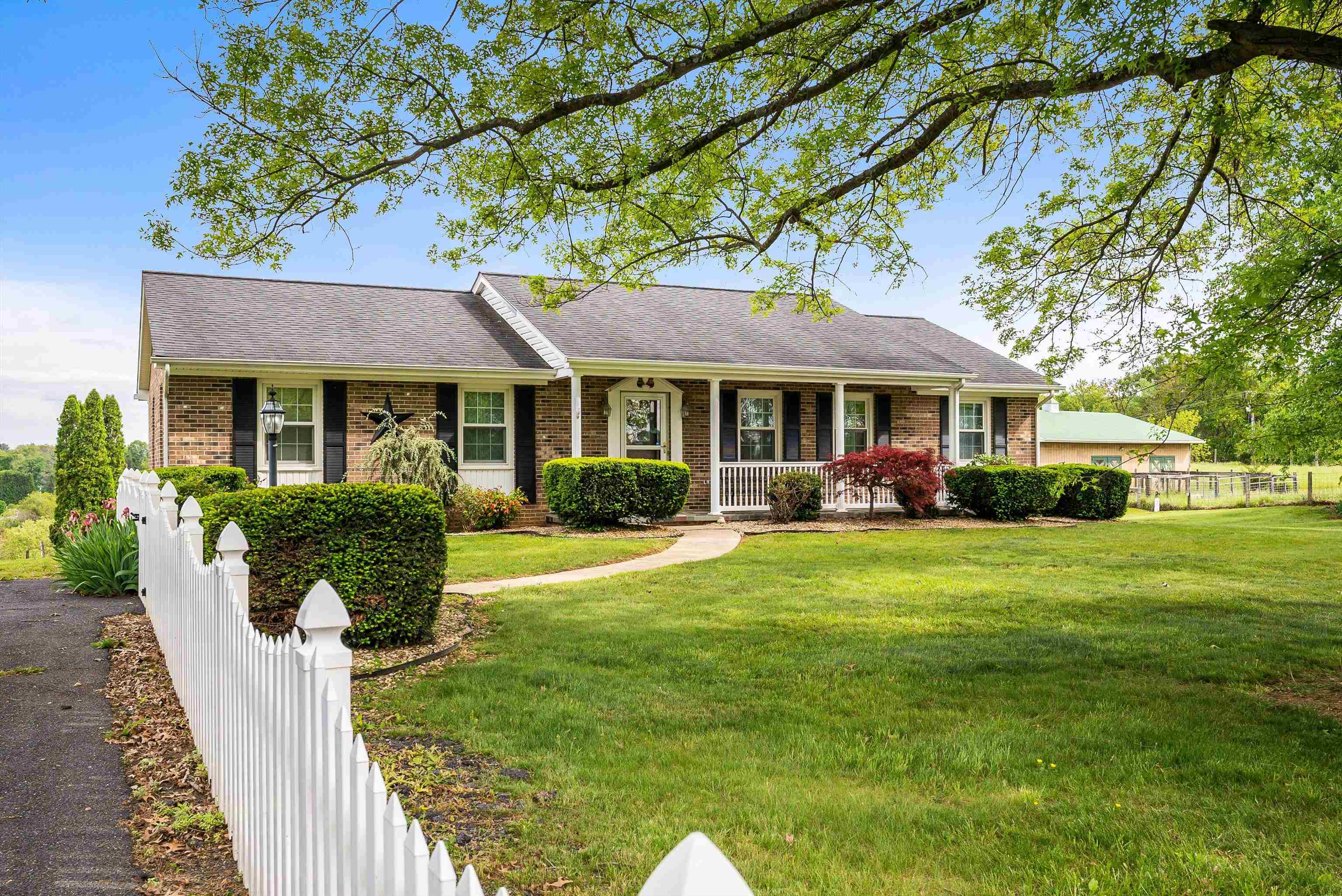 816 Todd Road Mount Sidney, VA 24467 - Photo 2 of 66 a front view of a house with a yard table and chairs