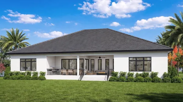 a house that has a big yard and potted plants in front of it