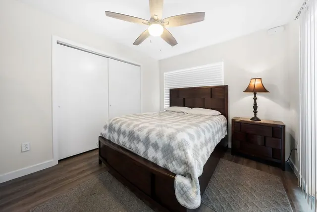 a bed sitting in a bedroom and chandelier fan
