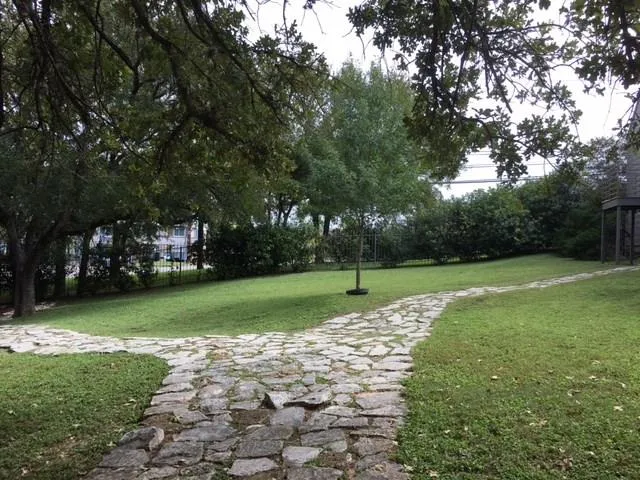 a view of a house with yard and deck