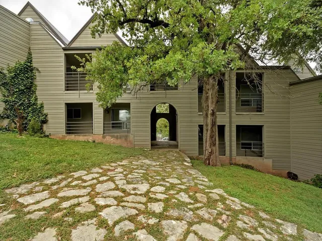 a view of a house with a tree in a yard