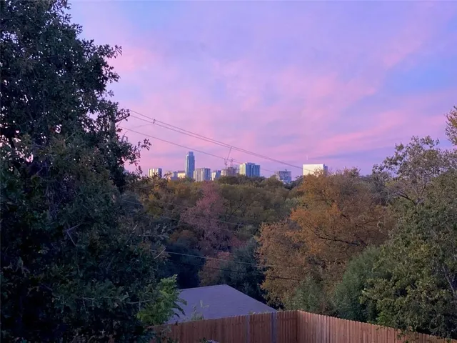 an aerial view of residential houses with city and ocean