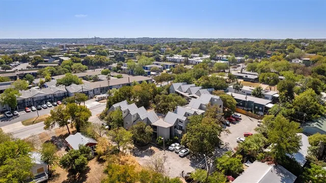 an aerial view of multiple houses with outdoor space