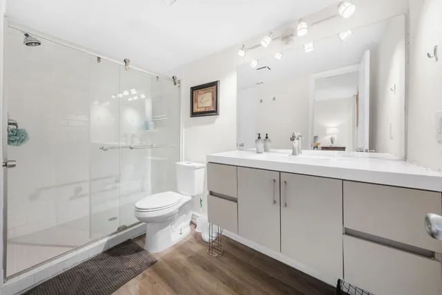 a bathroom with a sink toilet and shower