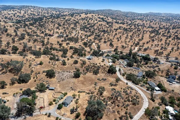 an aerial view of residential houses with city view