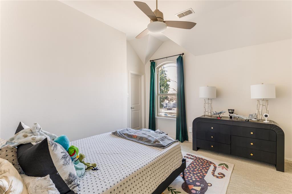3914 Dunhaven Road Dallas, TX 75220 - Photo 19 of 21 a bedroom with a bed and a chandelier
