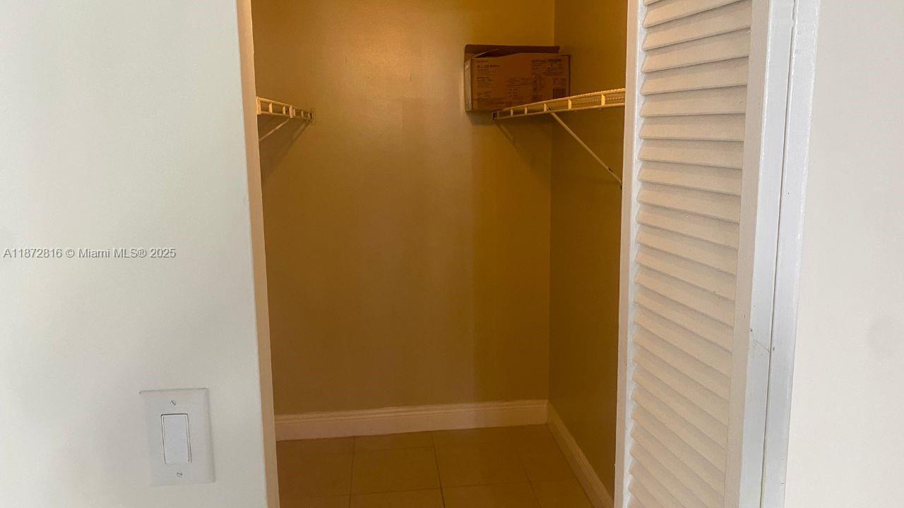 7075 Northwest 186th Street, Unit C110 Hialeah, FL 33015 - Photo 12 of 16 a view of walk in closet