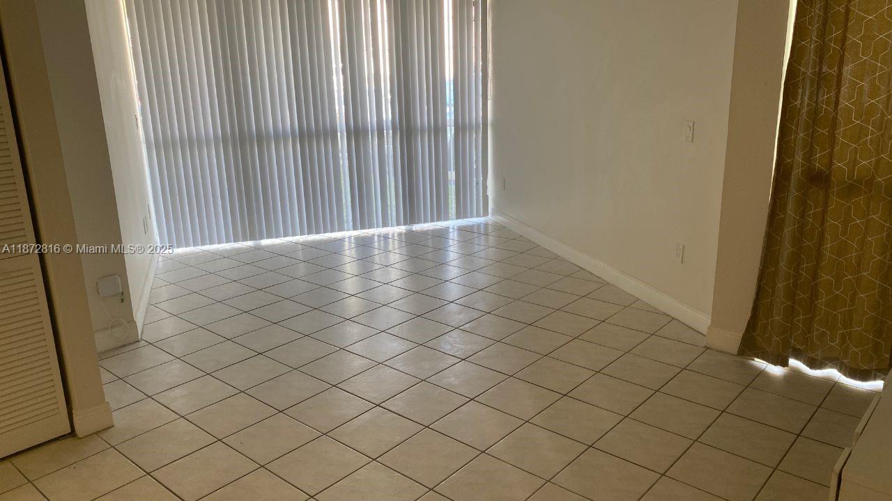 7075 Northwest 186th Street, Unit C110 Hialeah, FL 33015 - Photo 16 of 16 an empty room with wooden floor