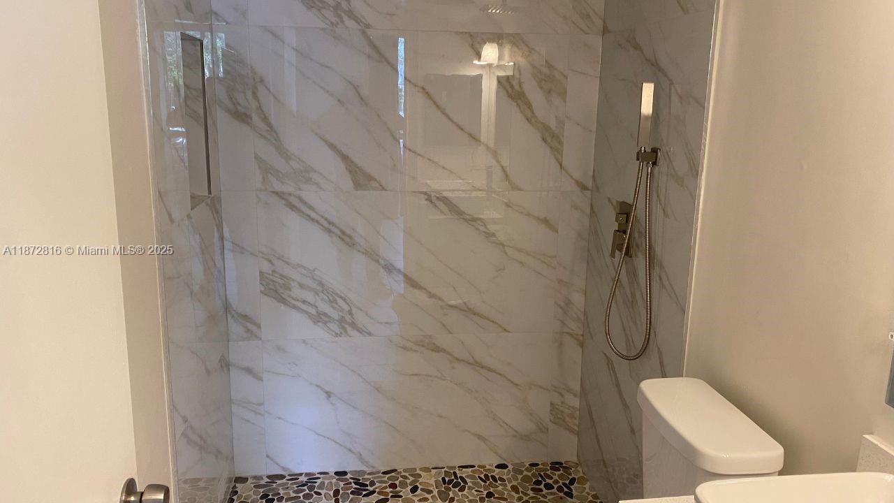7075 Northwest 186th Street, Unit C110 Hialeah, FL 33015 - Photo 9 of 16 a bathroom with a toilet and a shower