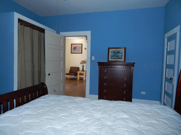 a bedroom with a bed and a dresser