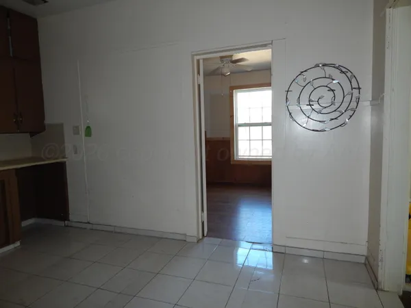 a view of a livingroom with wooden floor and a window