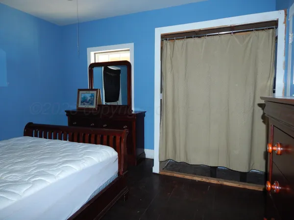a bedroom with double bed and a window