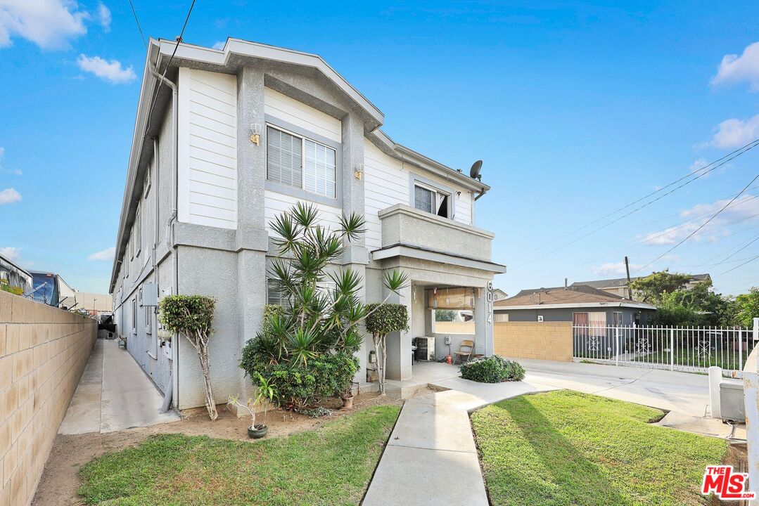6014 Ferguson Drive Commerce, CA 90022 - Photo 2 of 22 a front view of a house with a yard