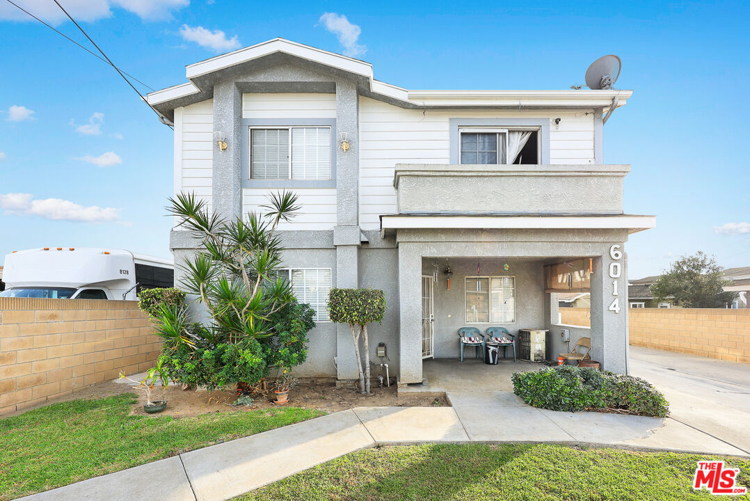 6014 Ferguson Drive Commerce, CA 90022 - Photo 4 of 22 a front view of a house with garden