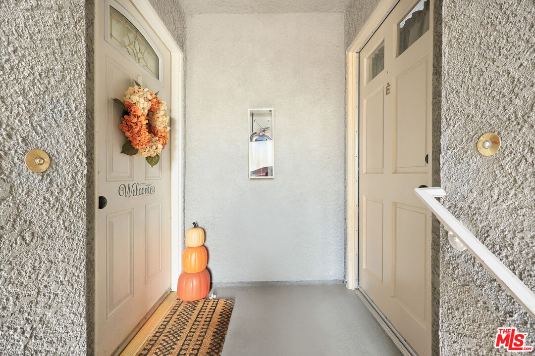 6014 Ferguson Drive Commerce, CA 90022 - Photo 9 of 22 a view of a hallway with paintings on the wall