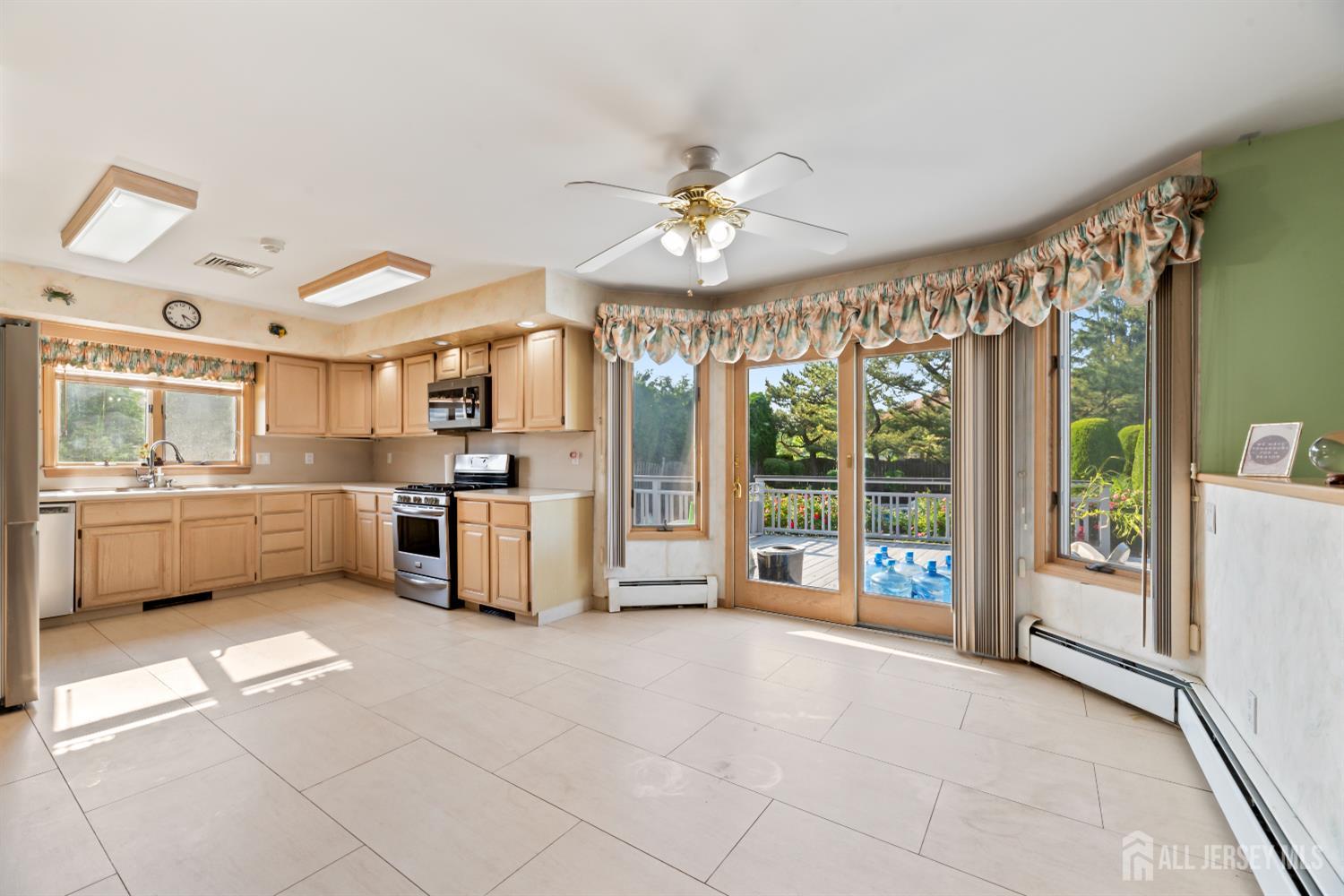 6 Allison Court Edison, NJ 08820 - Photo 13 of 53 a large white kitchen with a large window and stainless steel appliances