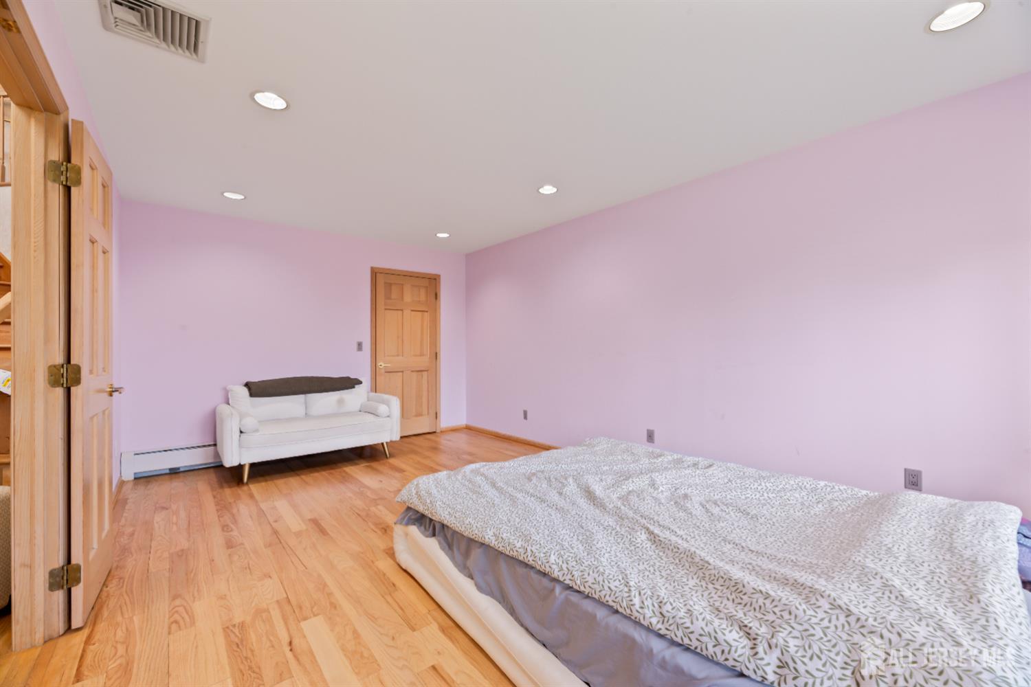 6 Allison Court Edison, NJ 08820 - Photo 22 of 53 a bedroom with a bed and a wooden floor