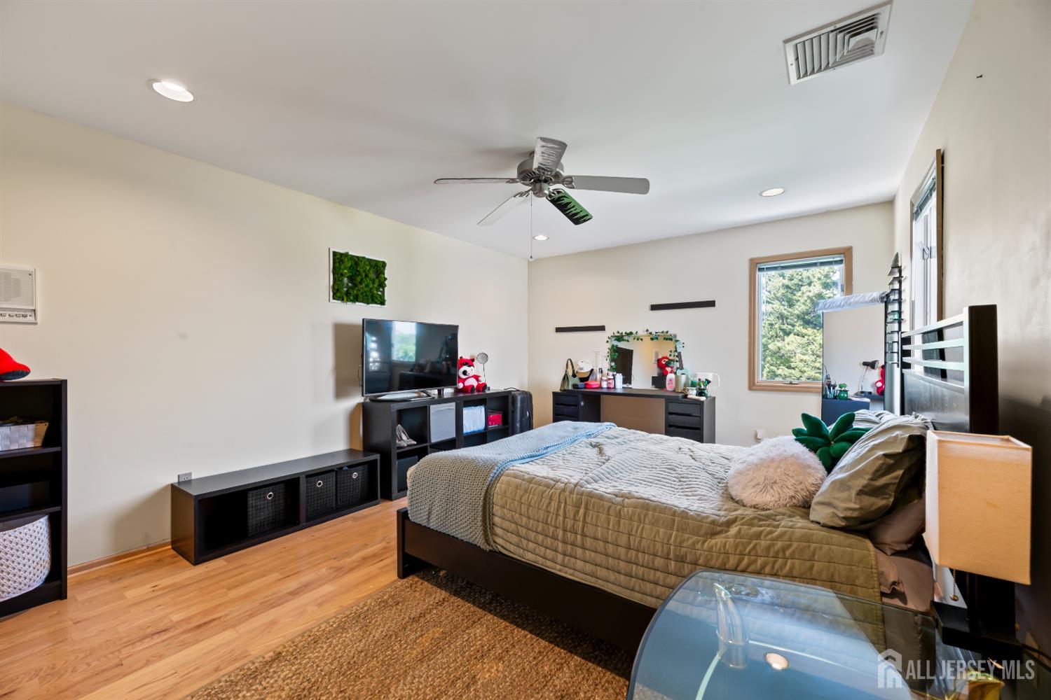 6 Allison Court Edison, NJ 08820 - Photo 29 of 53 a bedroom with a bed and a flat screen tv