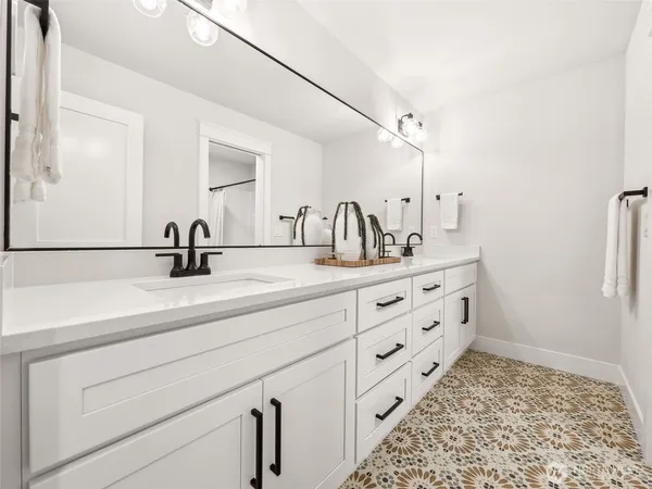 a bathroom with a double vanity sink and mirror