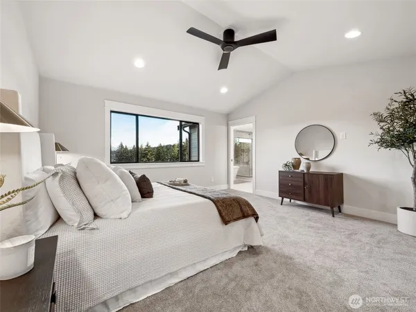 a bedroom with a large bed and a chandelier