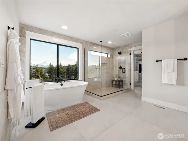 a bathroom with a tub shower and sink