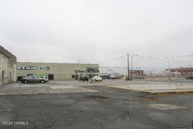 a view of a road with a building and ocean view