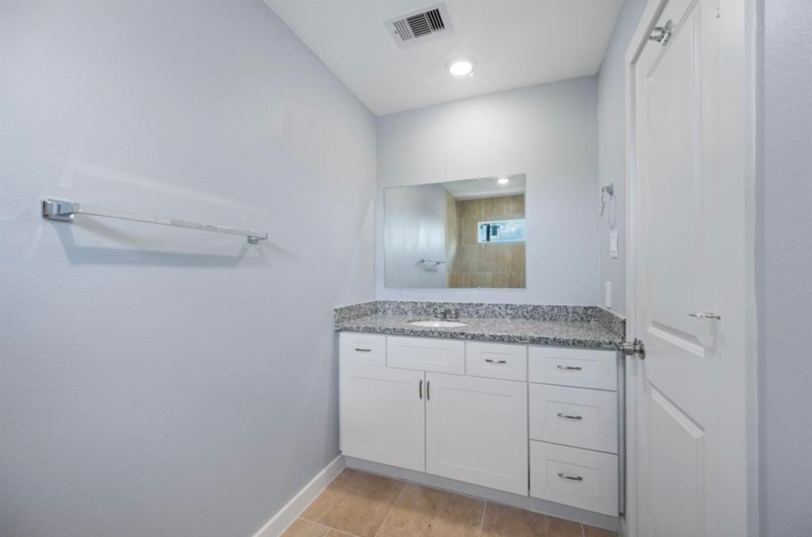 622 Maple Way Houston, TX 77015 - Photo 17 of 23 a bathroom with a granite countertop sink and a mirror