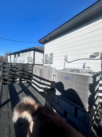 a view of a patio with table and chairs a barbeque with wooden floor and fence